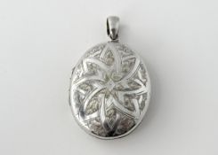 A late 19thc white metal oval double sided locket with engraved gilt intials M.R.I: l. x 5.5cm w.