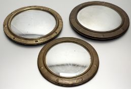 A collection of three convex mirror panels with brass metal porthole style frames. (smallest