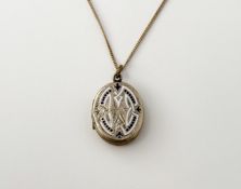 An Edwardian yellow metal enamel front oval locket with engraved initials W.D.R. verso: l. x 2.5cm