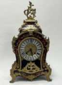 A Louis XIV-style French boulle mantel clock, decorated with all-over cut brass decoration and