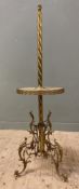 A brass and onyx standard lamp, c. 1930, spiral column over circular table and raised on scrolled