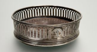 A silver wine slide with lancet pierced border with family crest and motto Virtutis Gloria Merces