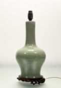 A Chinese celadon glazed dragon and scrolling pattern bottle vase later converted table lamp, raised