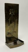 An Arts and Crafts brass embossed wall candle holder, decorated with a fleur de lis to front (h.