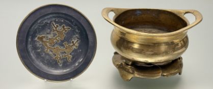 A Chinese twin handled brass censer raised on tripod feet (h-10cm w-22.5cm) with a raised fitted