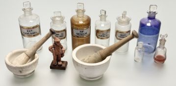 A group of six clear glass apothocary jars with gilt and gilt verre eglomise labels, in various