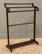 A mahogany four-bar towel rail, scrolled sides raised on square supports and bracket feet: H. 94cm