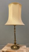 A brass candlestick-style table lamp, cream drum-style shade on a shaped column support: H. exc