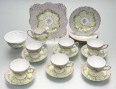 A Tuscan China in a green with yellow petal tips flower pattern part tea service comprising, six