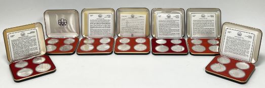 A Canadian Royal Mint full set of seven cased Olympic 1976 proof five dollar silver coins, each