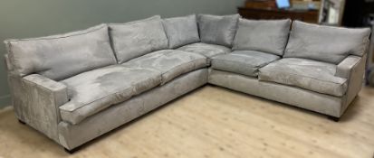 A large L-shape sofa by Bryce McKenzie, upholstered in grey suede with loose back and seat cushions,