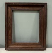 A 20thc stained and carved wooden picture frame (interior measurement 30.5cm x 37cm)