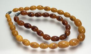 A butter scotch amber coloured oval bead necklace with screw fastening: l. x 19.5cm bead l. x 2.