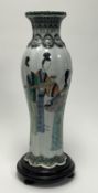 A 19thc Chinese Famille Verte vase of scalloped form, decorated with court women, raised on a turned