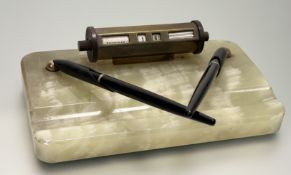 V An Art Deco green onyxdesk stand with a perpetual calender and a pair of roller ball pen