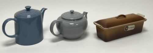 A collection of Le Creuset wares, comprising a 'Chambray' coffee pot (h. 19cm), a teapot in the '