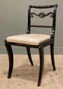 A Regency-style side chair, ebonised with rope-twist rail and cream drop-in seat, raised on sabre