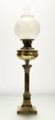 A late 19thc brass corinthian column converted oil lamp, raised on a stepped square plinth base,