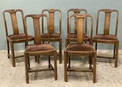 A set of six 1920s oak dining chairs, carved backs with central splat, brown drop-in seats raised on