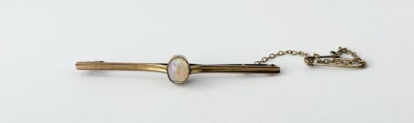 A 9ct gold bar brooch set oval cabochon fire opal approximately 0.75ct: l. x 5.5cm 2.43g