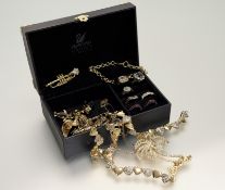 A Swarovski jewllery box with a black acrylic cushion cut paste stone P/Q together with a gilt metal