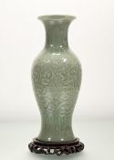 A Chinese celadon glazed, in a chrysanthemum pattern baluster later converted table lamp, raised