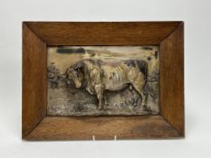 An early 20th century pressed metalware plaque of a bull in high relief, stamped G.G. Bommer to