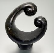 An African abstract sculpture footed centre piece in a carved black stone. (h-26.5cm)