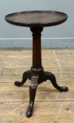 A George II mahogany wine table, the circular dished top on a tapering columnar standard over a