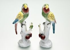 A pair of 19th century German porcelain models of colourful parrots after 18th century Meissen