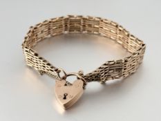 A 9ct gold gatelink bracelet, with heart padlock clasp. Length 17.5cm, 25 grams