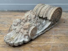 A large terracotta corbel, modelled with foliate scroll above a lion mask and with anthemion
