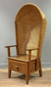 An oak-framed Orkney chair, with canopy back, the woven straw back above a plank seat flanked by
