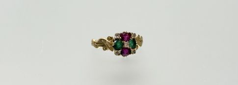 A ruby, emerald and diamond cluster ring, the pair of round-cut rubies and pair of round-cut