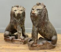 A near pair of 19thc Continental fire clay seated lion figures, one with pierced base, the other