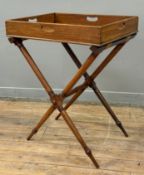 A late 19th century mahogany butler's tray on stand, the rectangular galleried tray with four