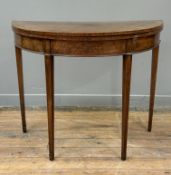 A George III satinwood inlaid mahogany demilune foldover card table, the top with a satinwood band