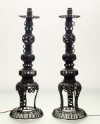A pair of bronzed metal candlesticks, probably Japanese, early 20th century, pierced, of baluster