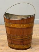 An early George III oval brass-bound coopered walnut peat bucket, with brass swing handle (lacking