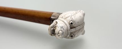 A carved ivory handled and silver-collared malacca cane, possibly Japanese, c. 1900, the handle