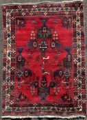 A hand-knotted Persian Afshar rug, central panel with stylized animals and vases containing floral