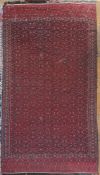 A hand-knotted Turkoman Yomut kilim rug, flatwoven with allover Tekke gul motifs on deep red ground,
