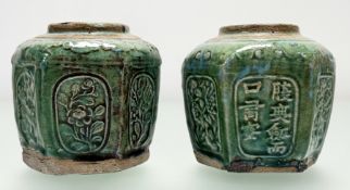A pair of Shiwan ginger jars, probably late 19th century, in characteristic green glaze on an