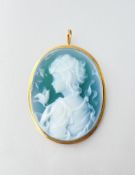 An 18ct gold mounted green cameo brooch / pendant, oval, carved with a young girl and a bird, in a