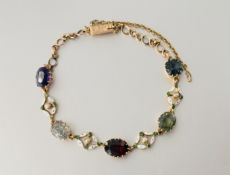 An Edwardian multi-gem set and enamel bracelet, claw-set with a round-cut sapphire, oval-cut