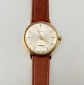 Garrard & Co., a gentleman's 9ct gold wristwatch, c. 1970, the silvered dial with gilt baton