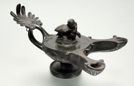 A Grand Tour patinated bronze oil lamp after the Antique, with double spout, the cover modelled with