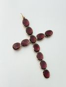 A large 19th century garnet cross pendant, formed of twelve uniform oval-cut garnets mounted in