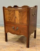 A George III mahogany bedside cupboard, the rectangular galleried top above a pair of doors over a