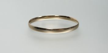 A plain 9ct gold bangle, stamped 